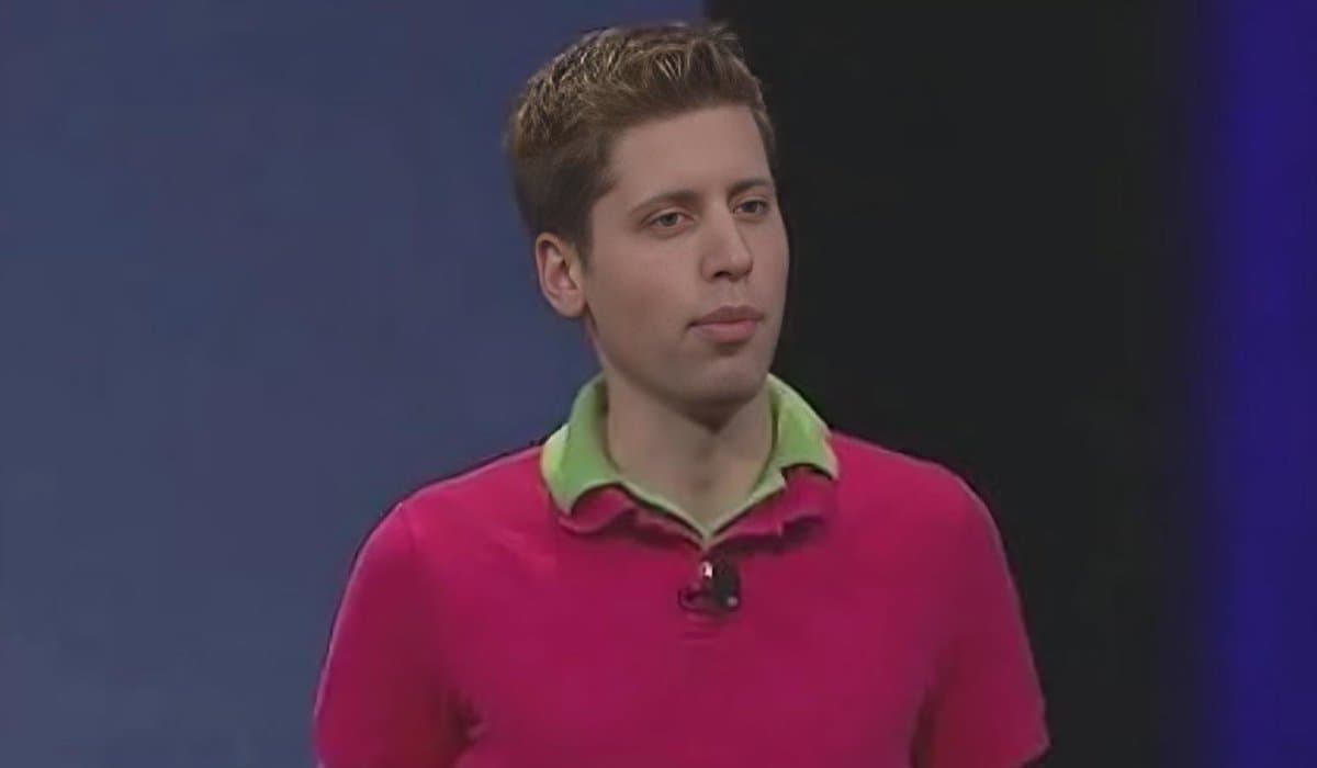 A young Sam Altman in a pink polo layered over a green polo, looking unreadably composed