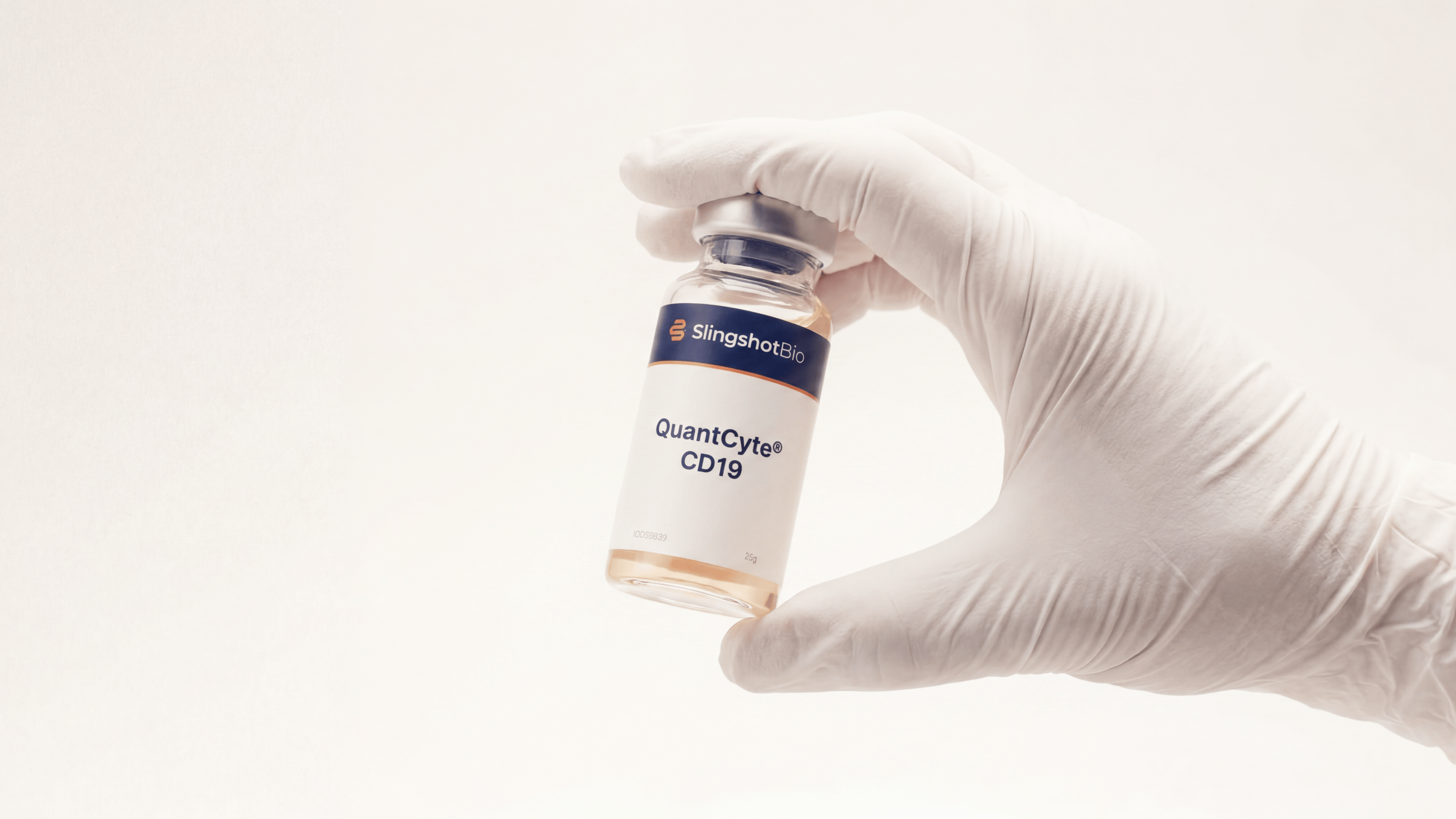 Gloved hand holding a Slingshot Bio vial